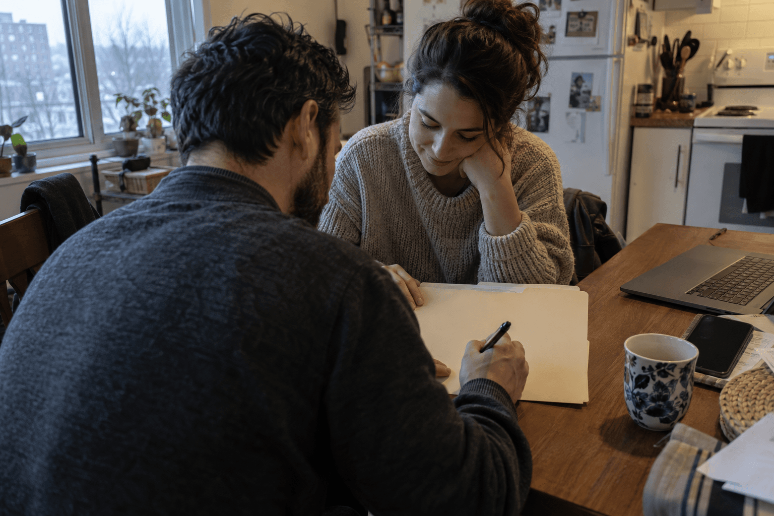A couple organizing a shared household folder.